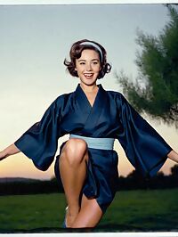 A brunette woman in 1950s fashion stands surprised amidst twilight orchard trees