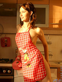 Sexy girl adel has some fun in the kitchen wearing only an apron and a thong